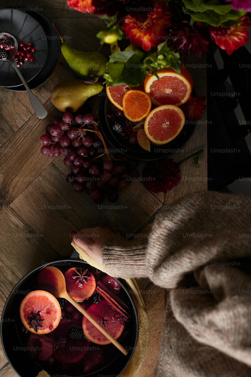 a table with a bowl of fruit and a bowl of oranges