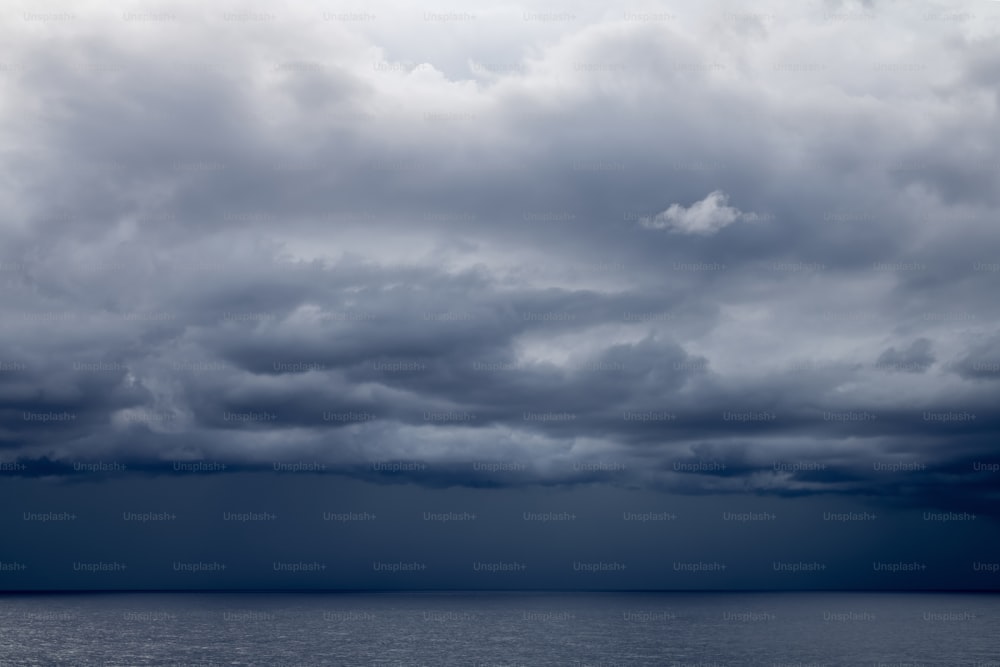 a large body of water under a cloudy sky