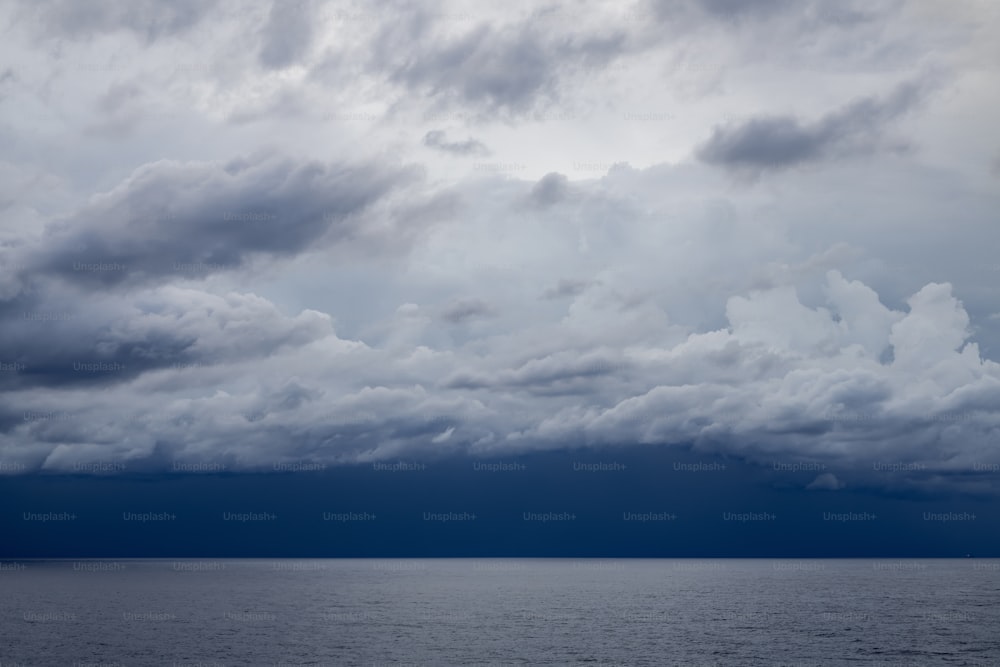 a large body of water under a cloudy sky