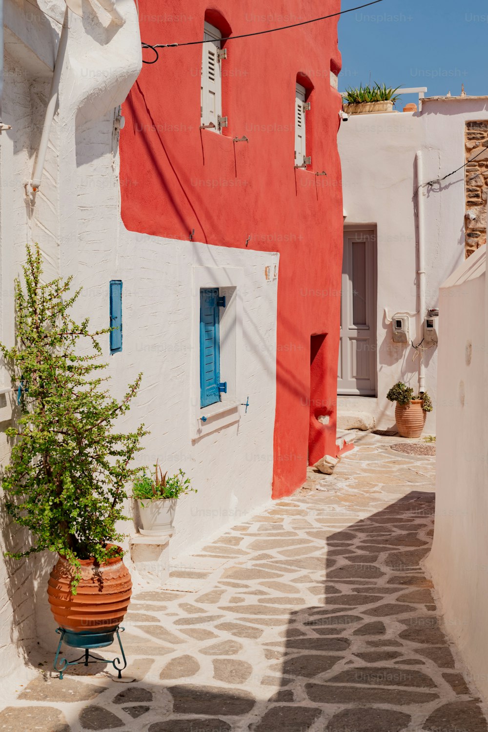 a red and white building with blue shutters