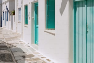 a row of white buildings with green doors