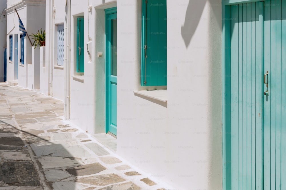 a row of white buildings with green doors