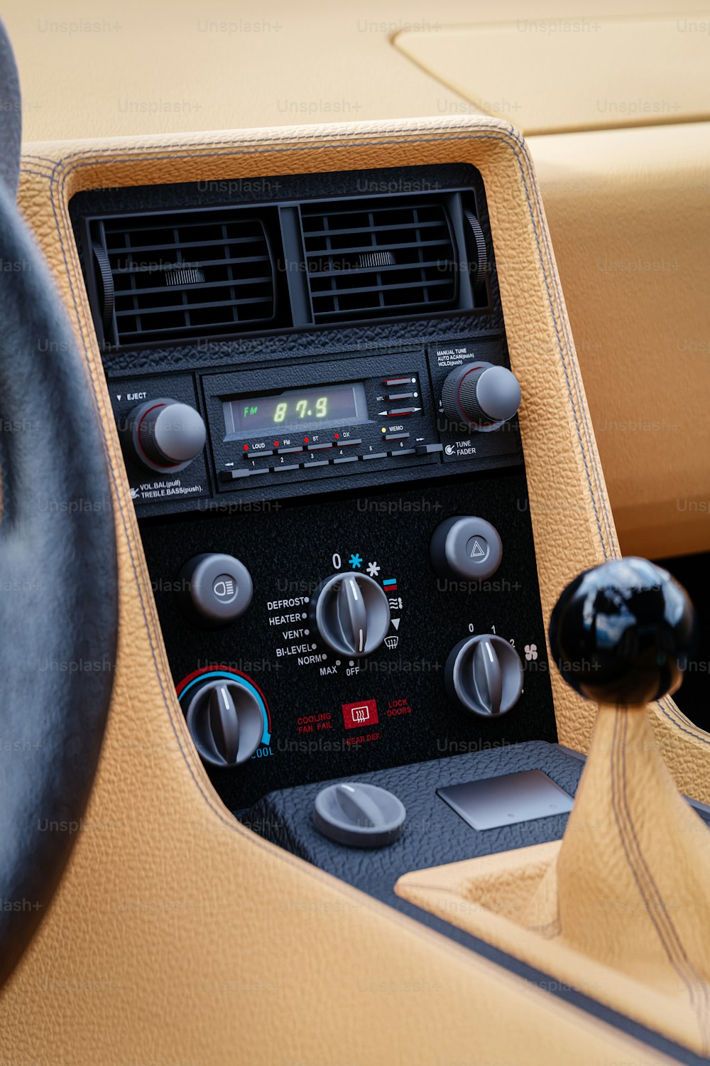 a car dashboard with a radio and a steering wheel