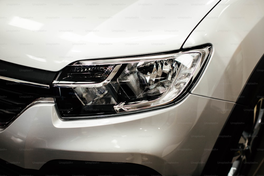 a close up of the front of a white car