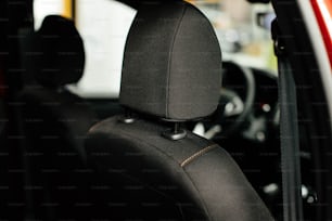 a close up of a car seat with a steering wheel