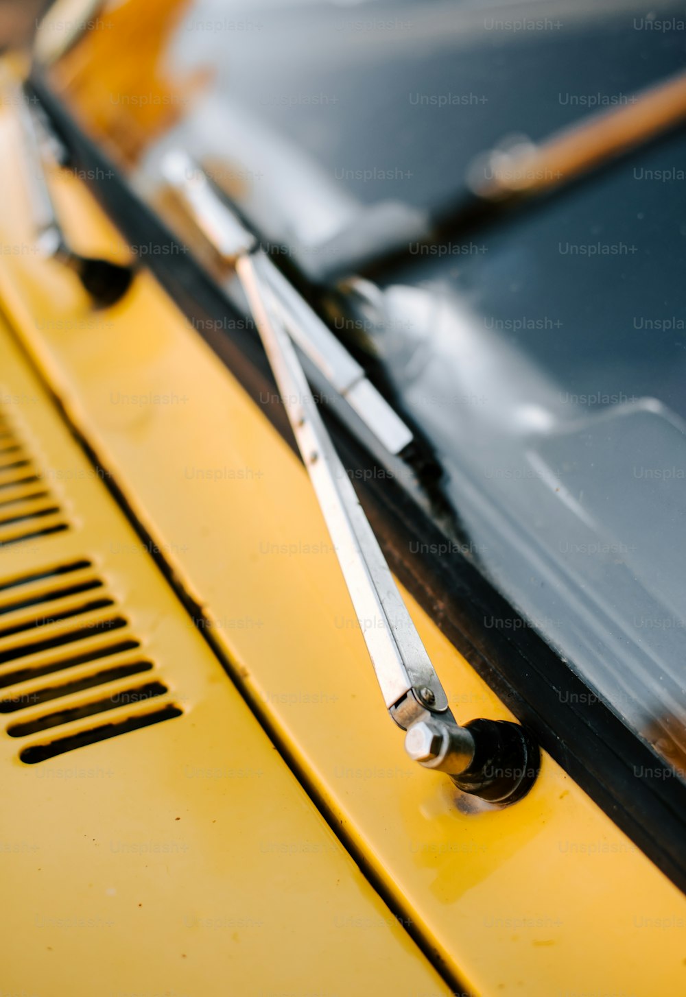 a close up of a yellow car with a pair of scissors on it