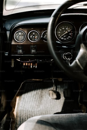 a dashboard of a car with a steering wheel