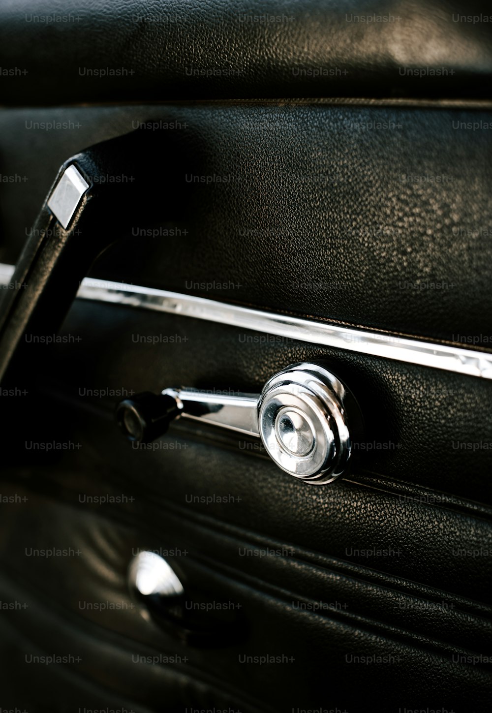 a close up of a door handle on a black suitcase
