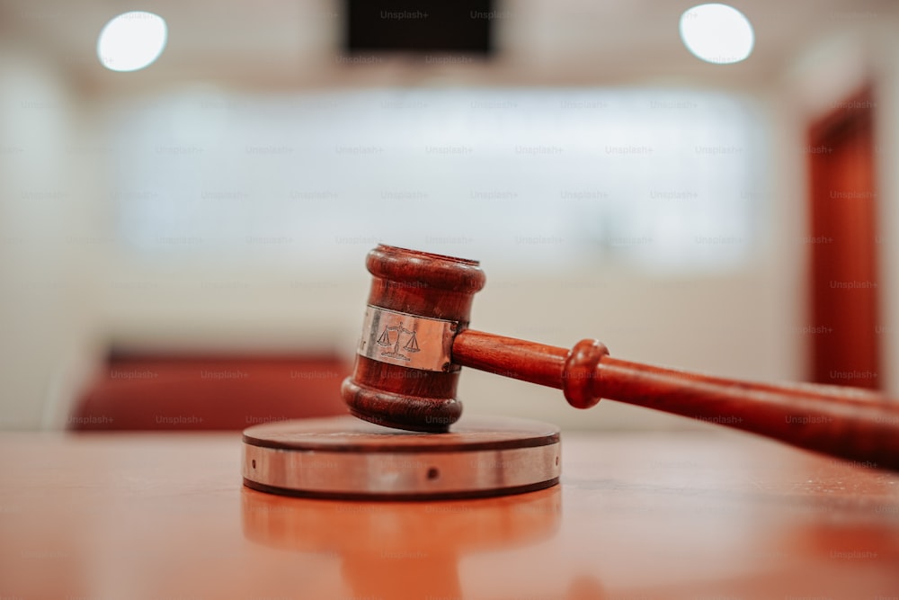 a wooden judge's hammer on top of a wooden table