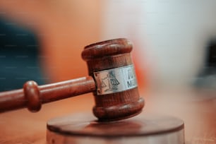 a wooden judge's hammer on top of a wooden table