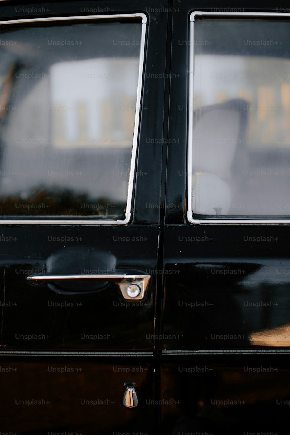 a close up of a door handle on a black car