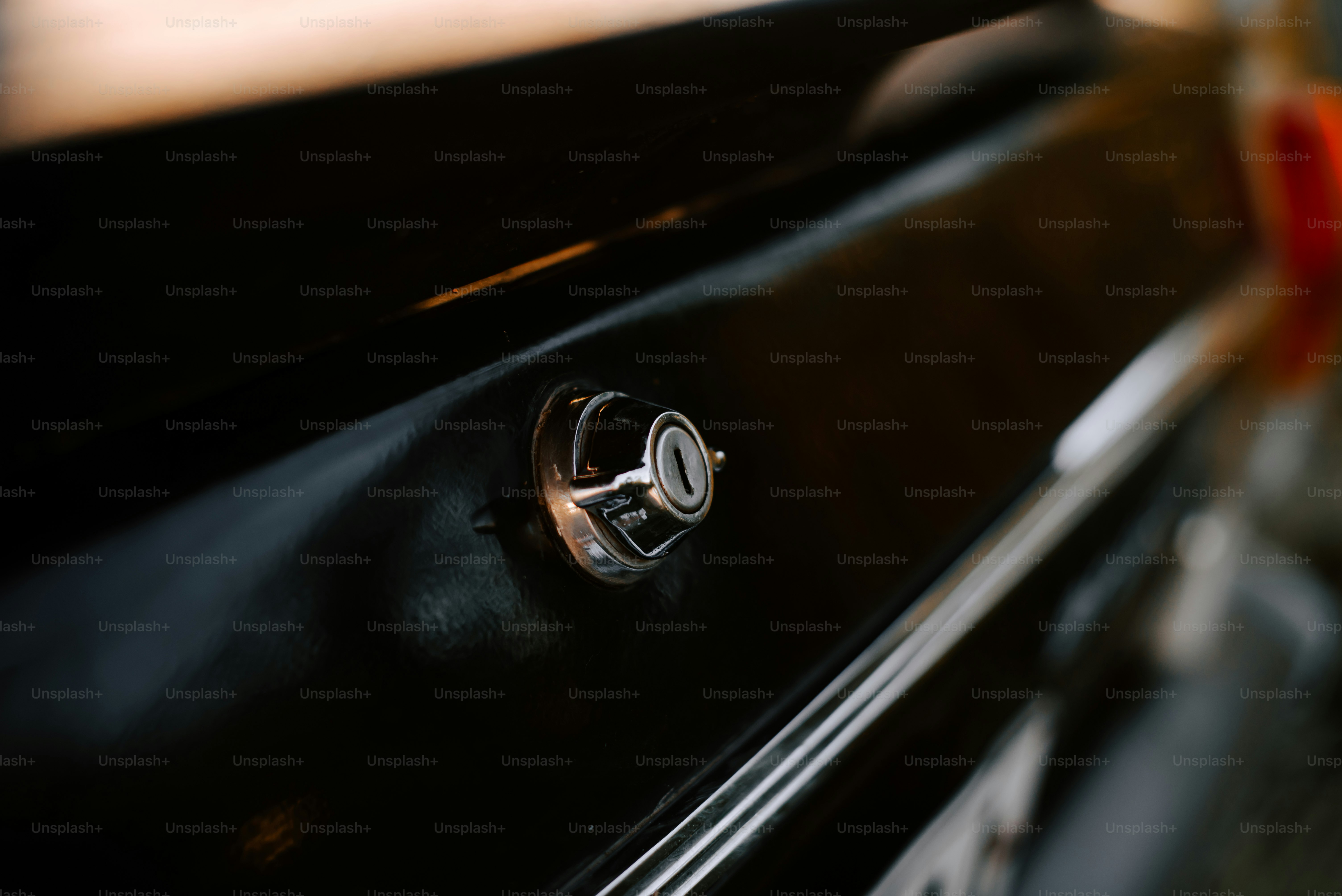 a close up of a door handle on a black cabinet