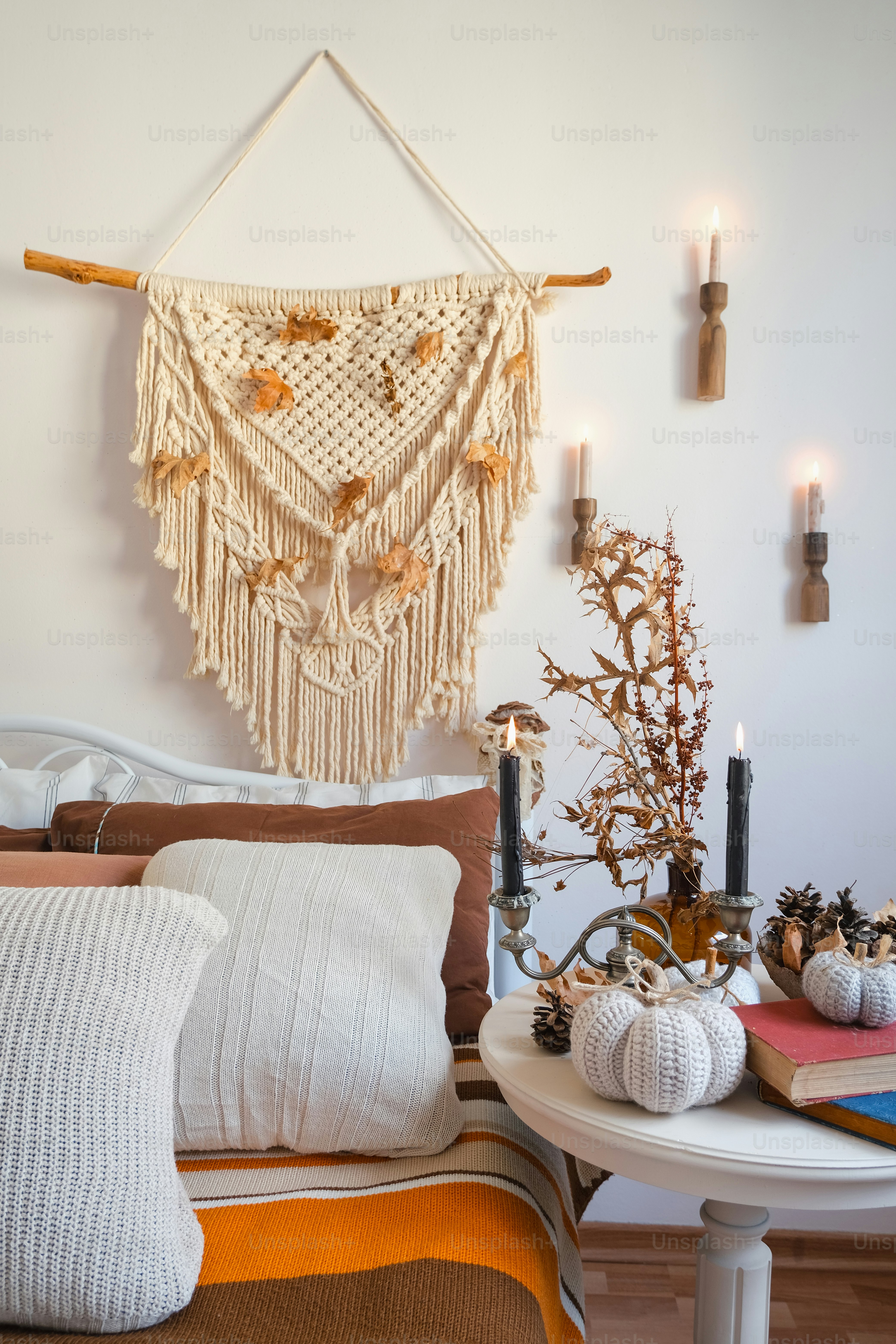 a bedroom with a bed and a table with candles on it