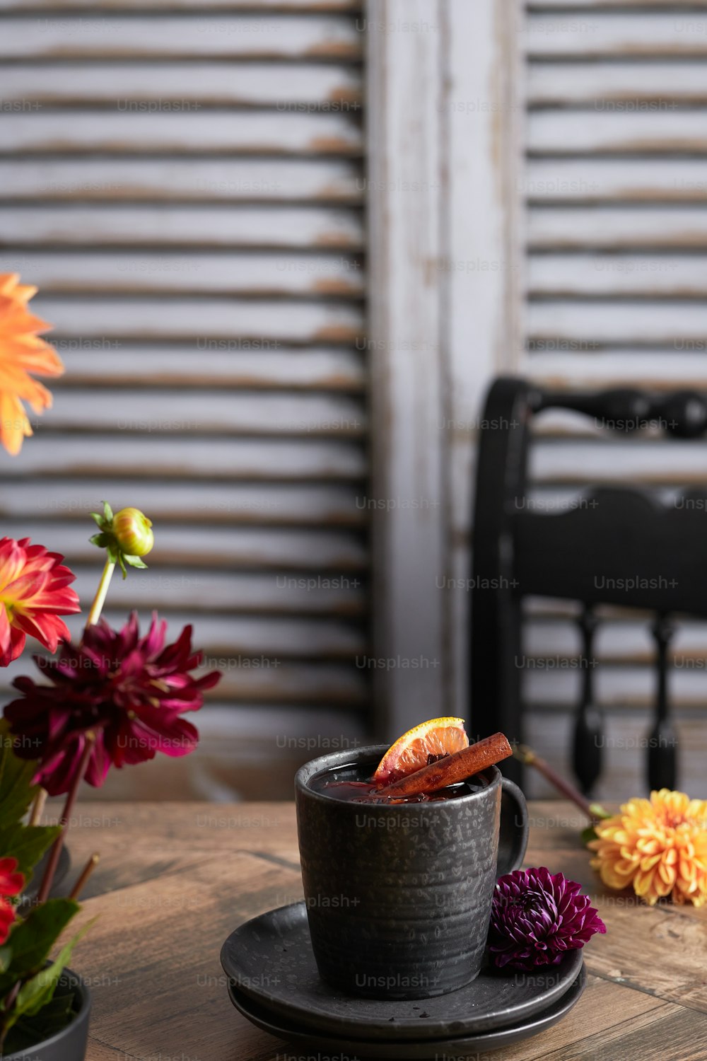 a wooden table topped with a cup of coffee