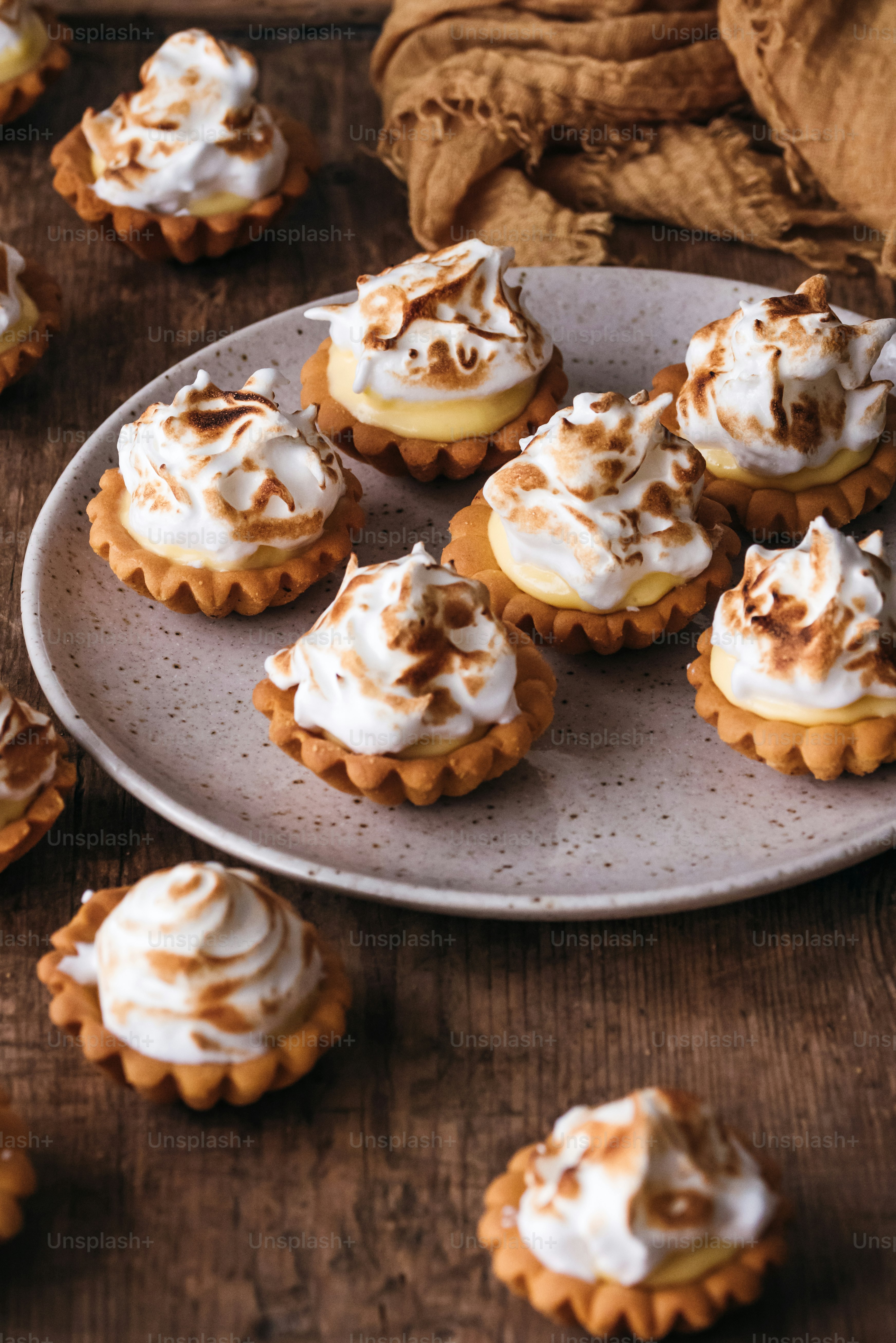 a white plate topped with mini desserts covered in frosting