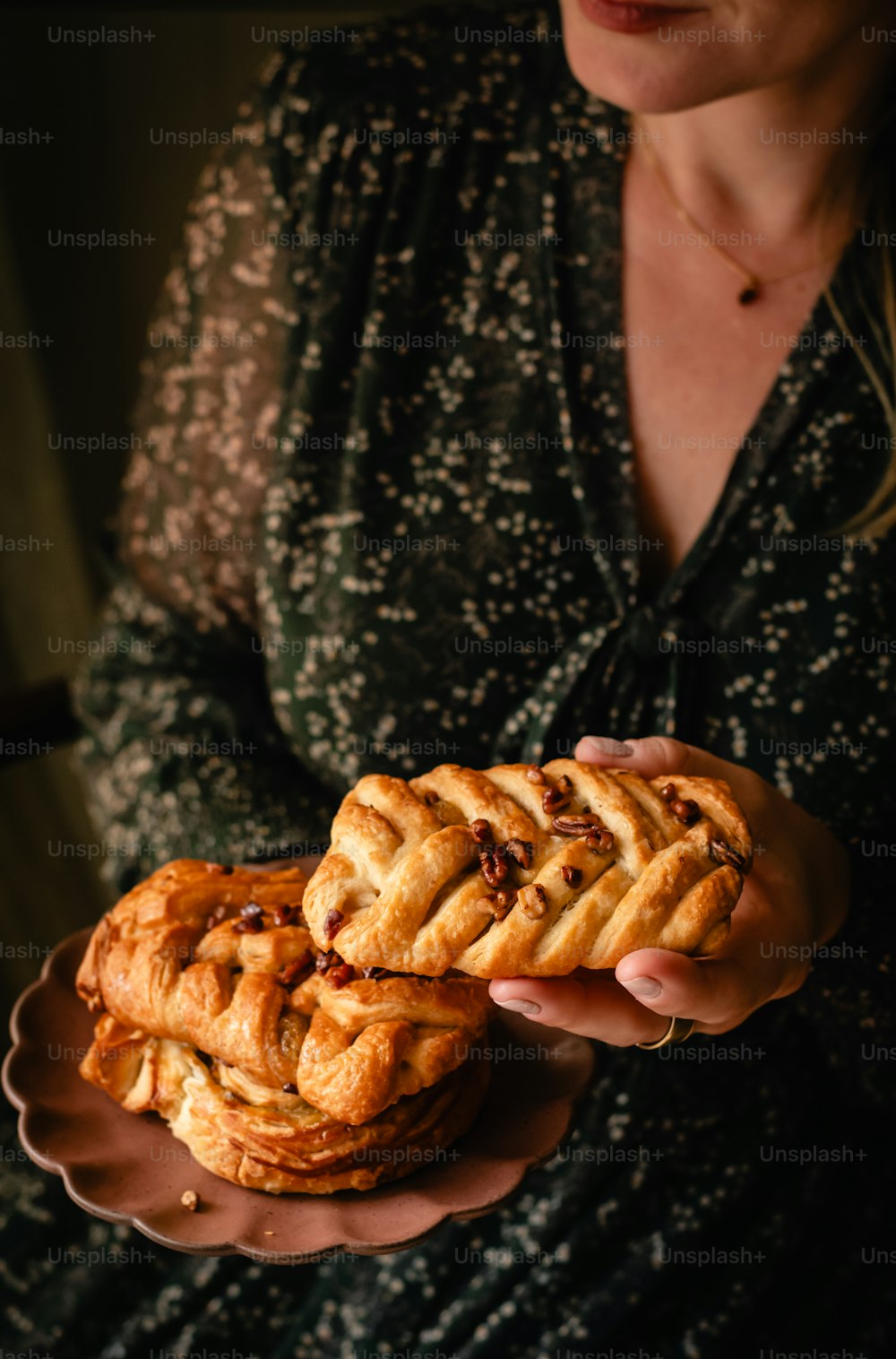 a woman holding a plate of food in her hands