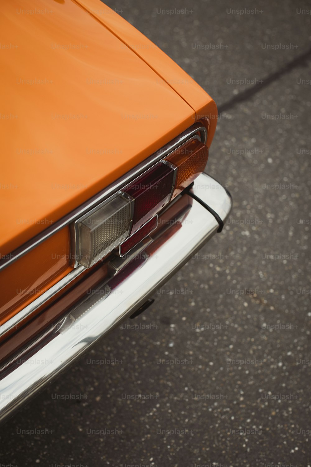 an orange car is parked on the street