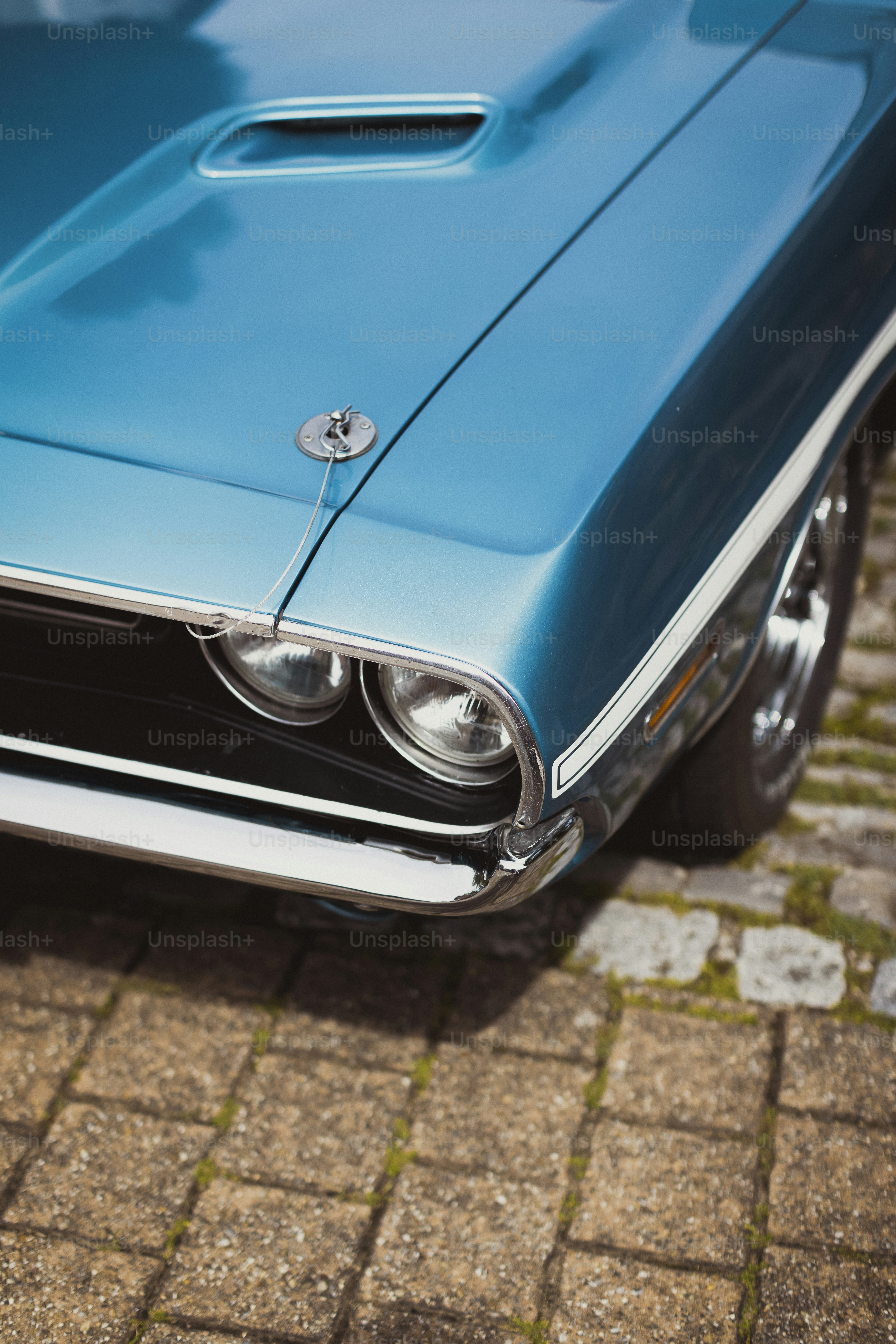 a close up of the front end of a blue car