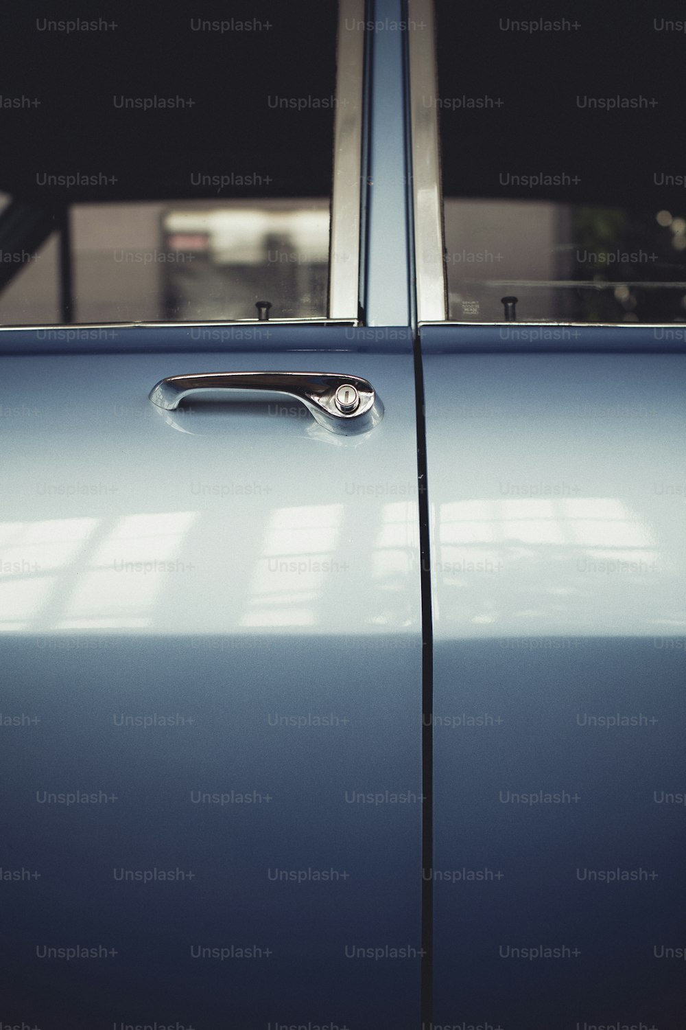 a close up of a door handle on a blue car