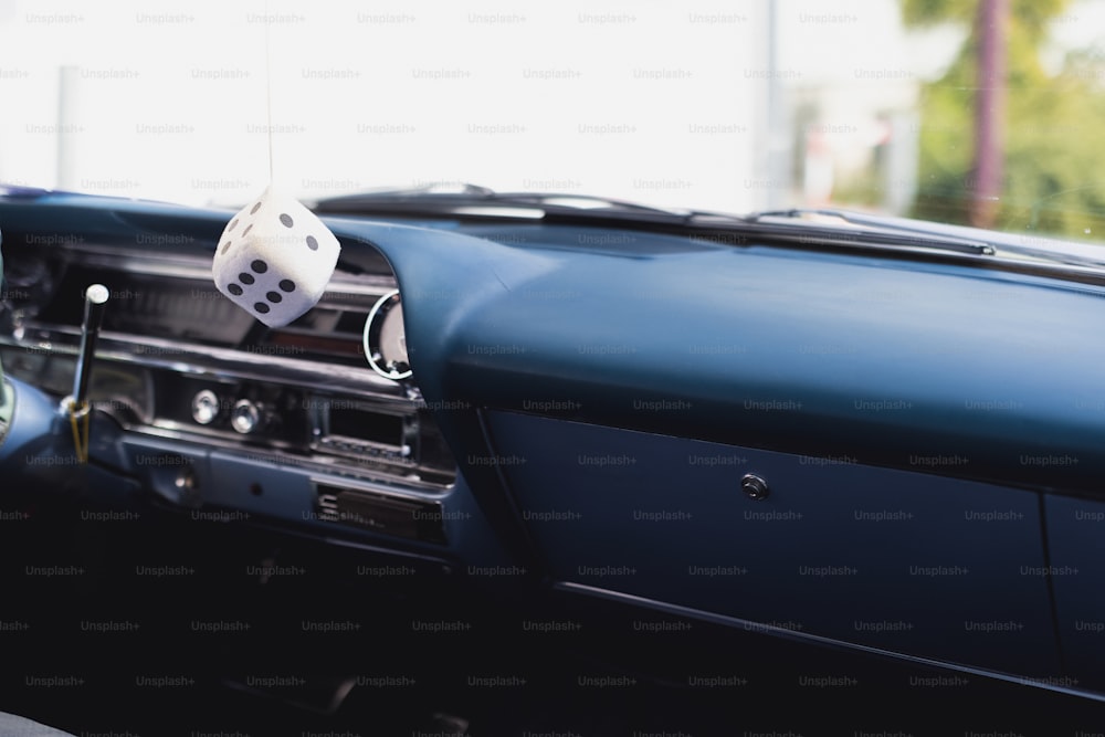 a car dashboard with a dice in the center of it