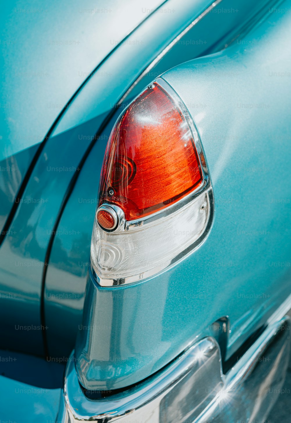 a close up of the tail light of a blue car