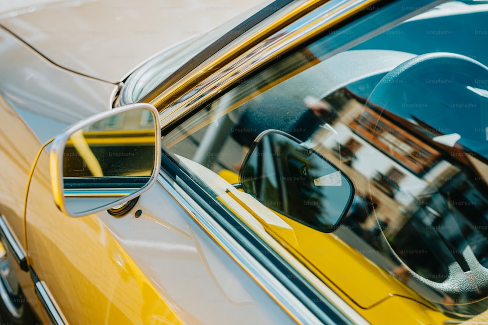 a side view mirror on a yellow car