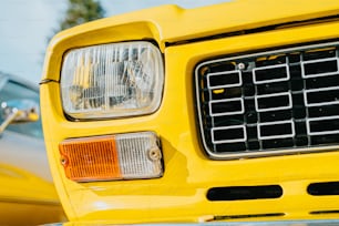 a close up of the front of a yellow truck
