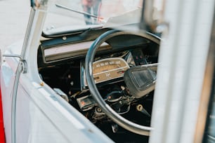 the interior of a car with a steering wheel and dashboard