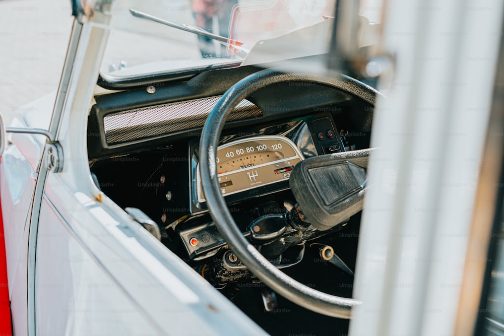 the interior of a car with a steering wheel and dashboard