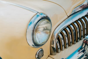 a close up of the front end of a classic car