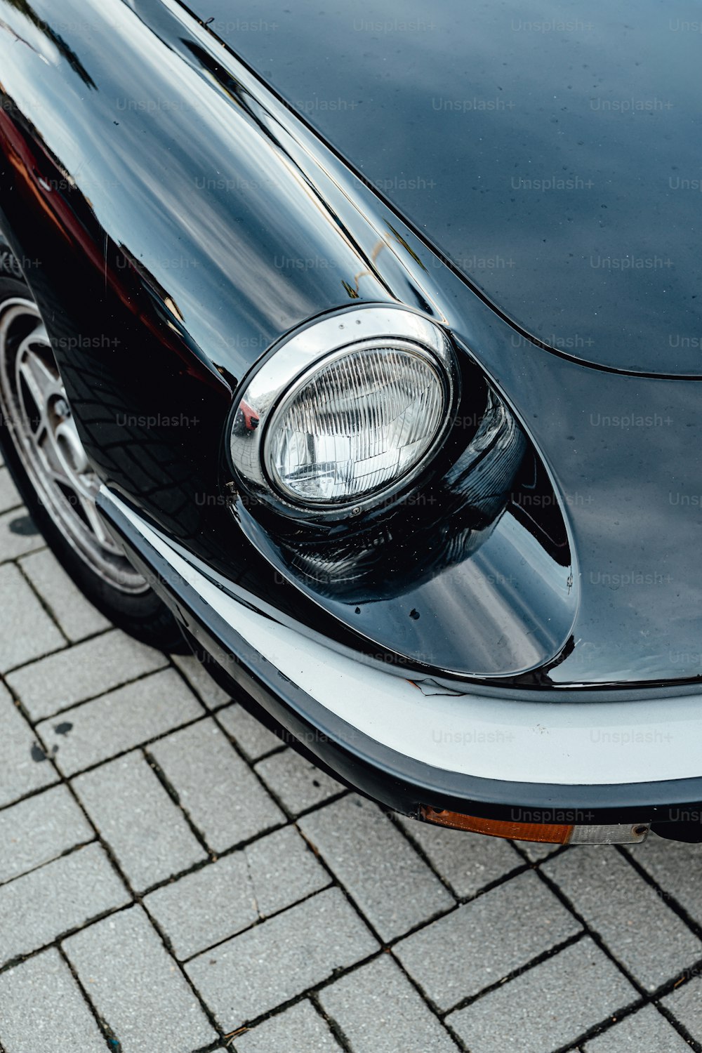 a close up of the front of a black sports car