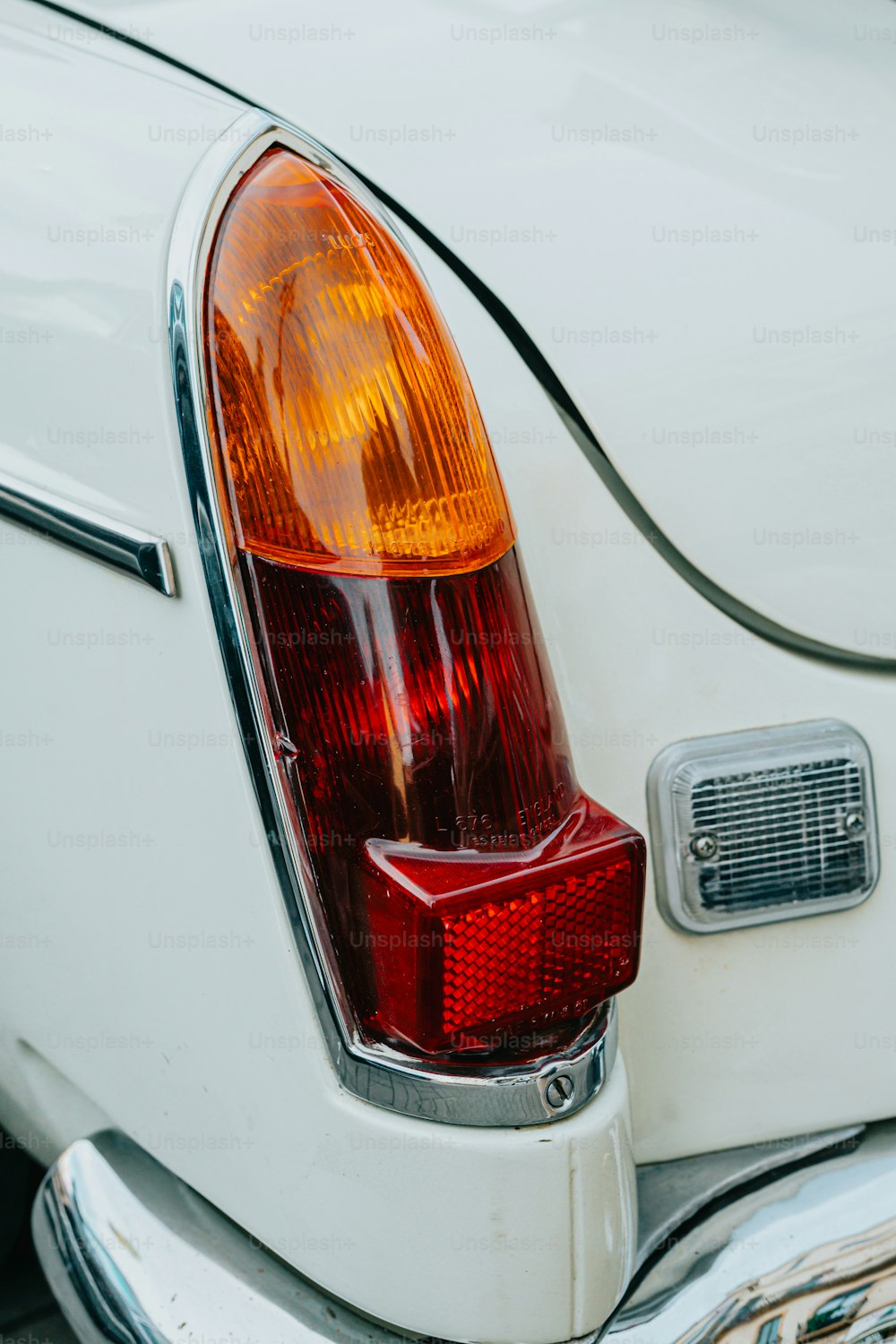 a close up of the tail light of a white car