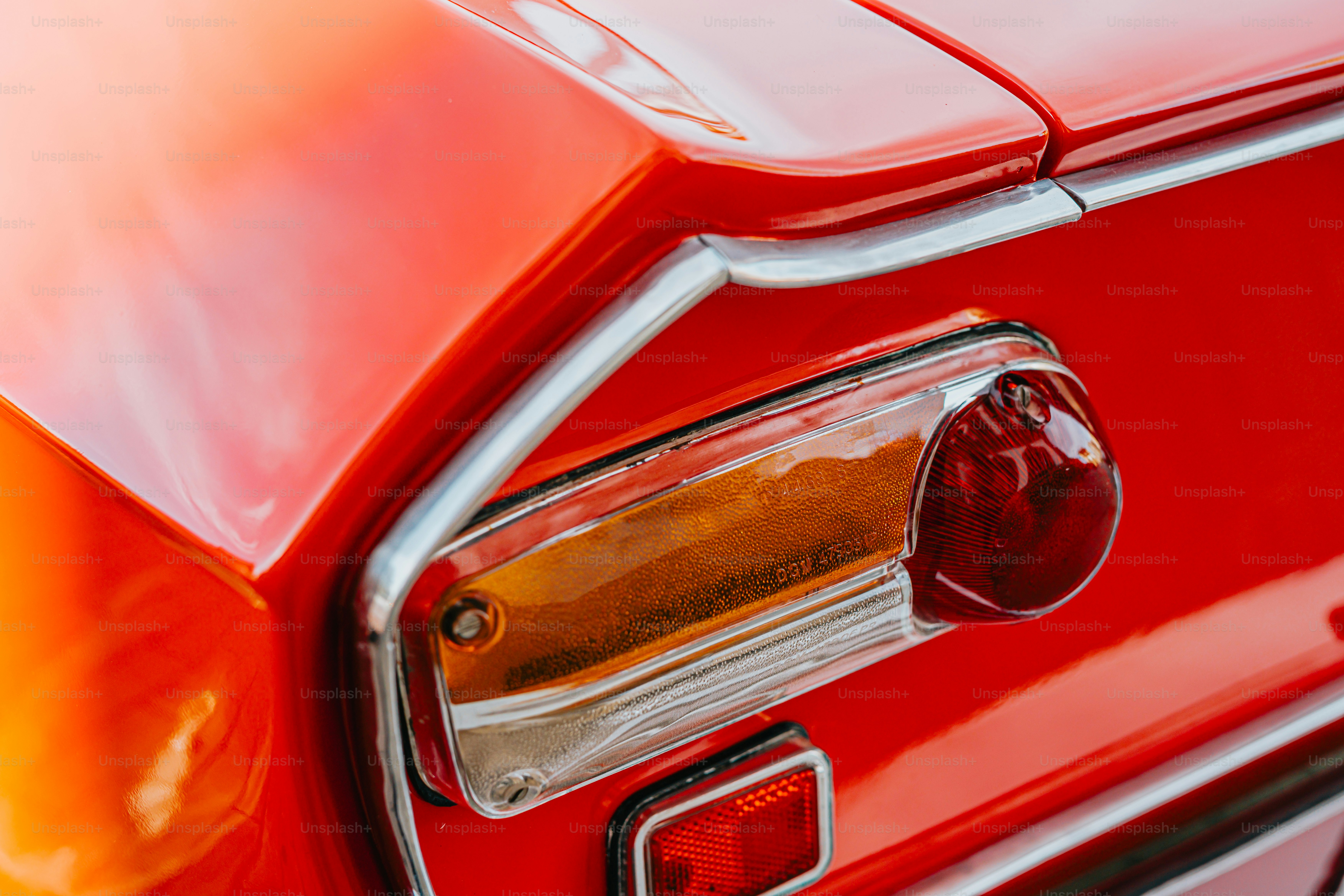 a close up of the tail light of a red car