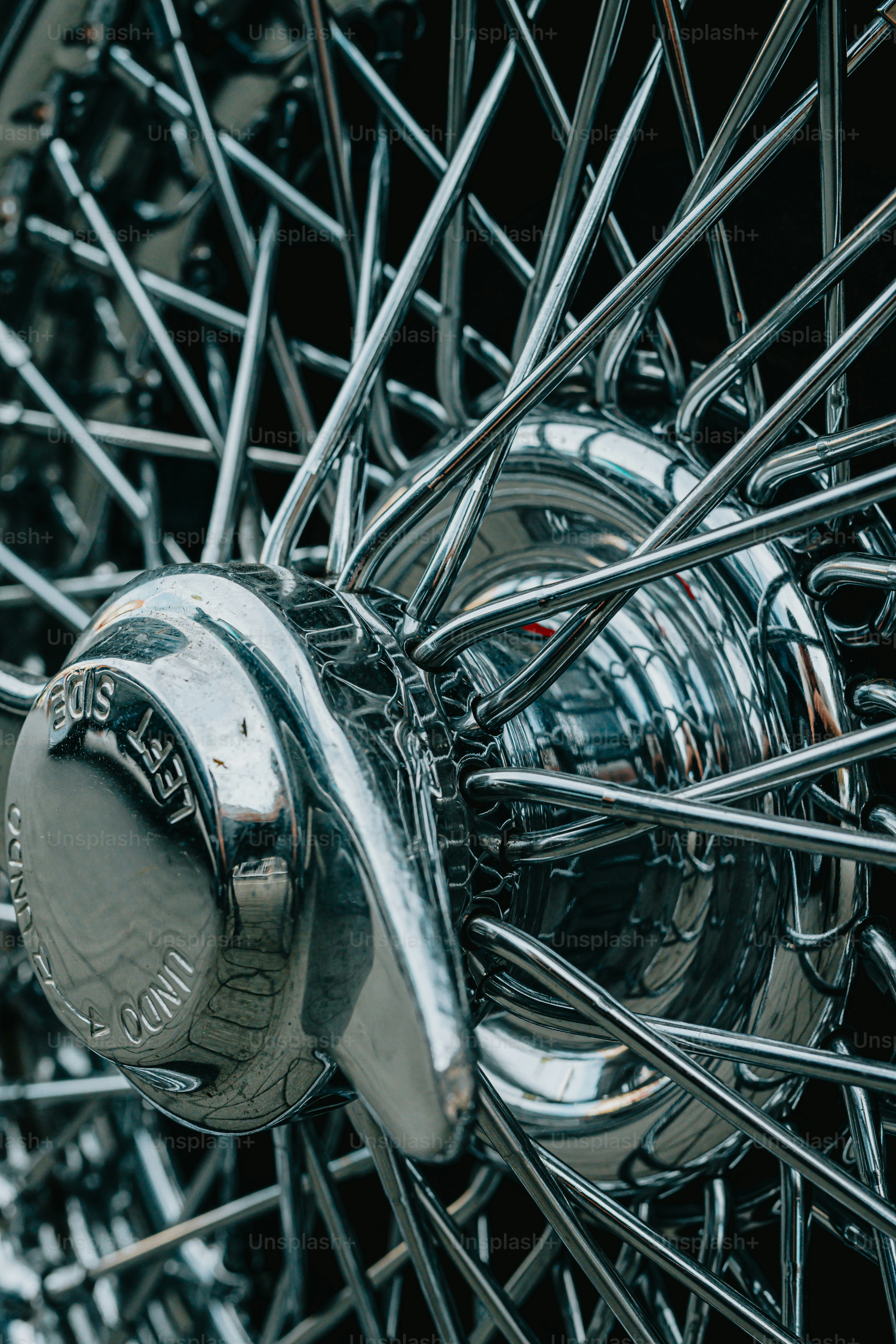 a close up of a metal object with spokes