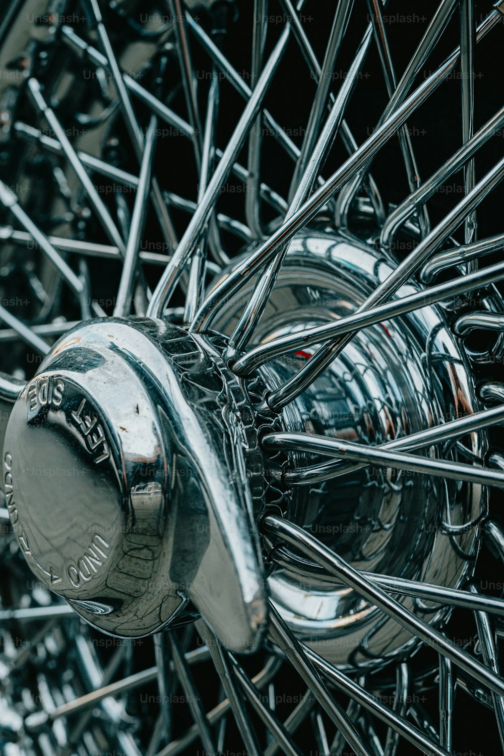 a close up of a metal object with spokes