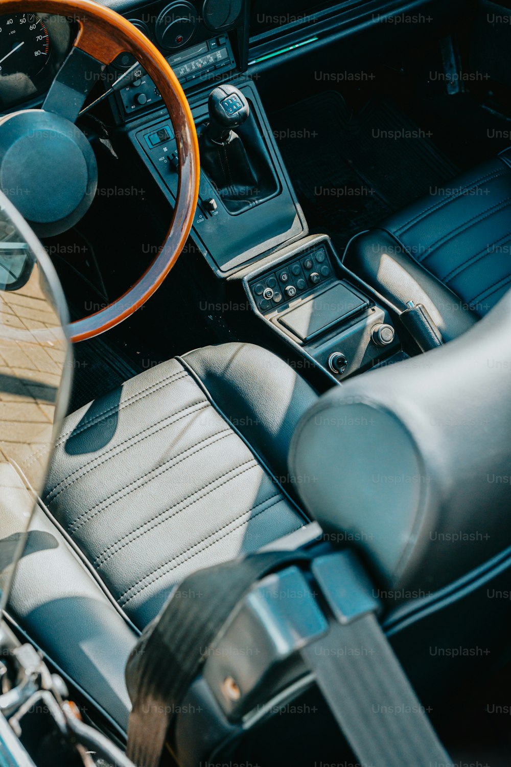 the interior of a car with a steering wheel and dashboard