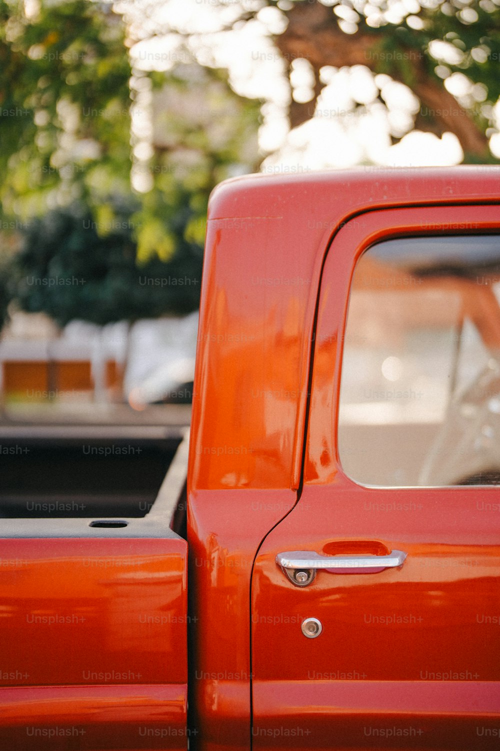 a red truck parked in a parking lot
