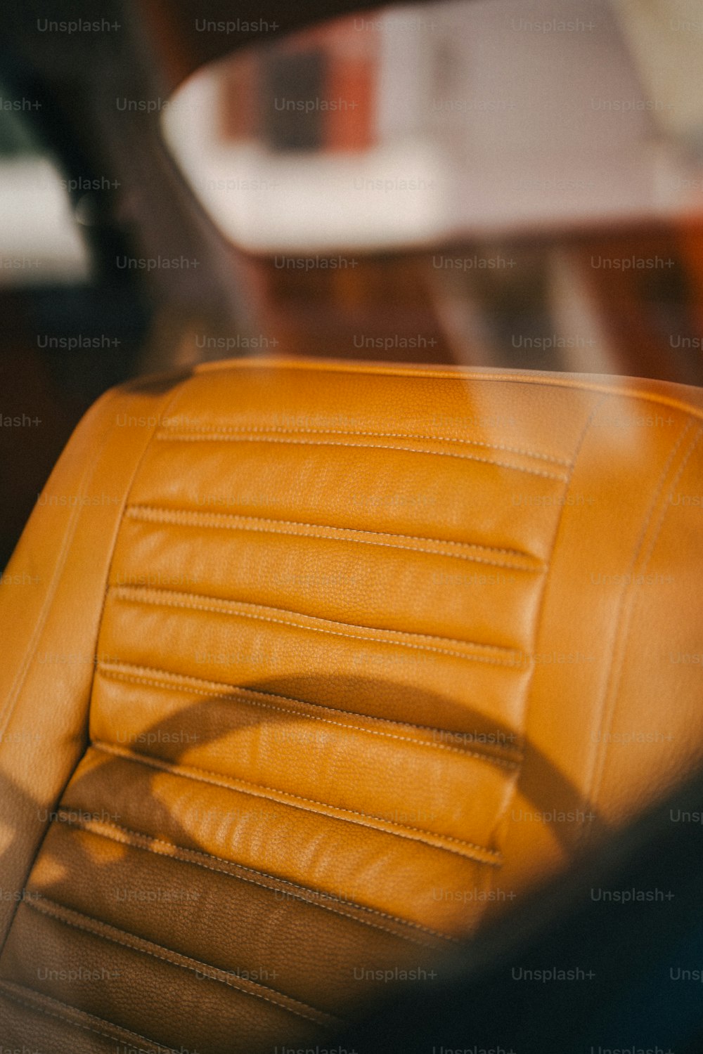 the interior of a car with a yellow leather seat