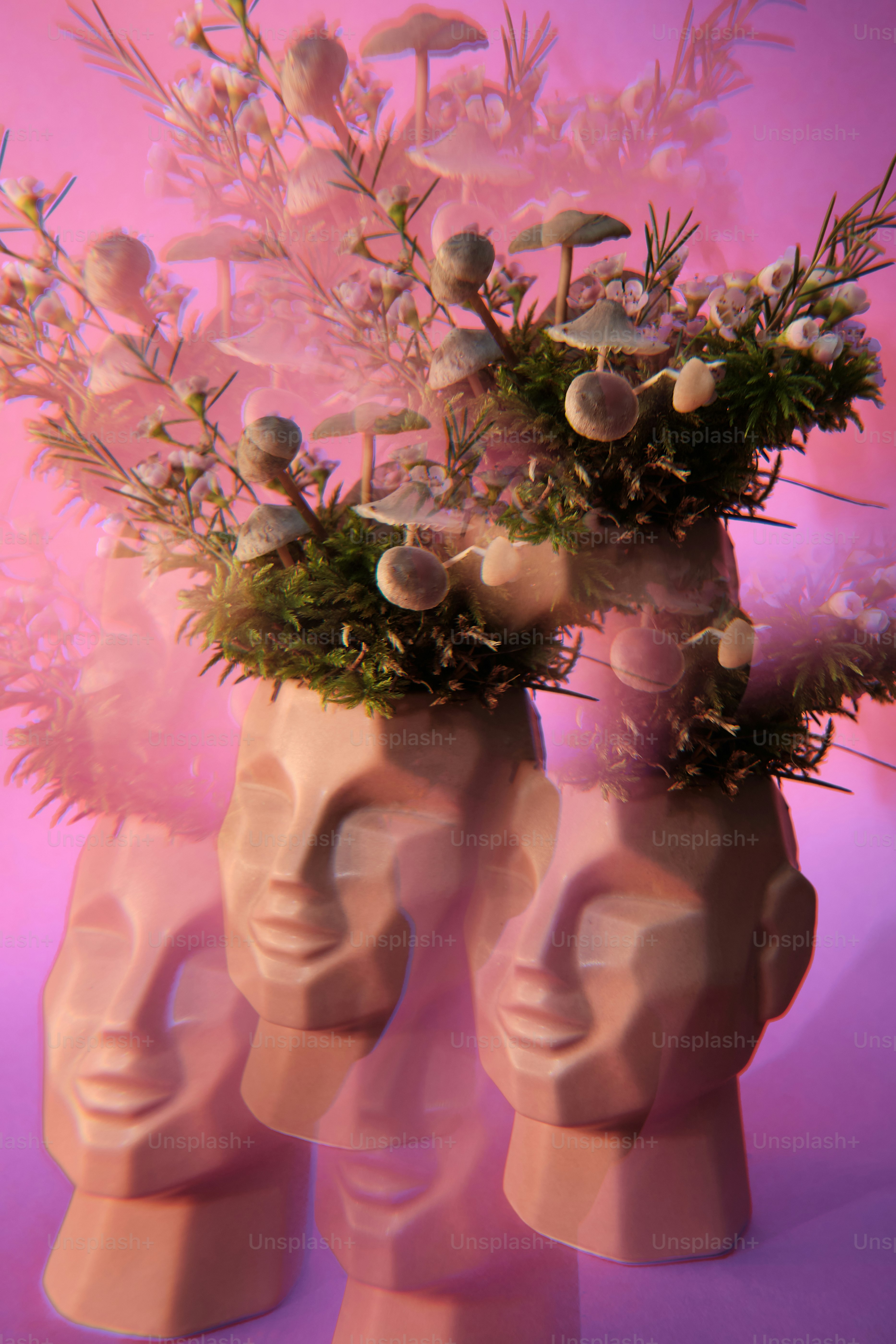 a couple of vases filled with flowers on top of a table