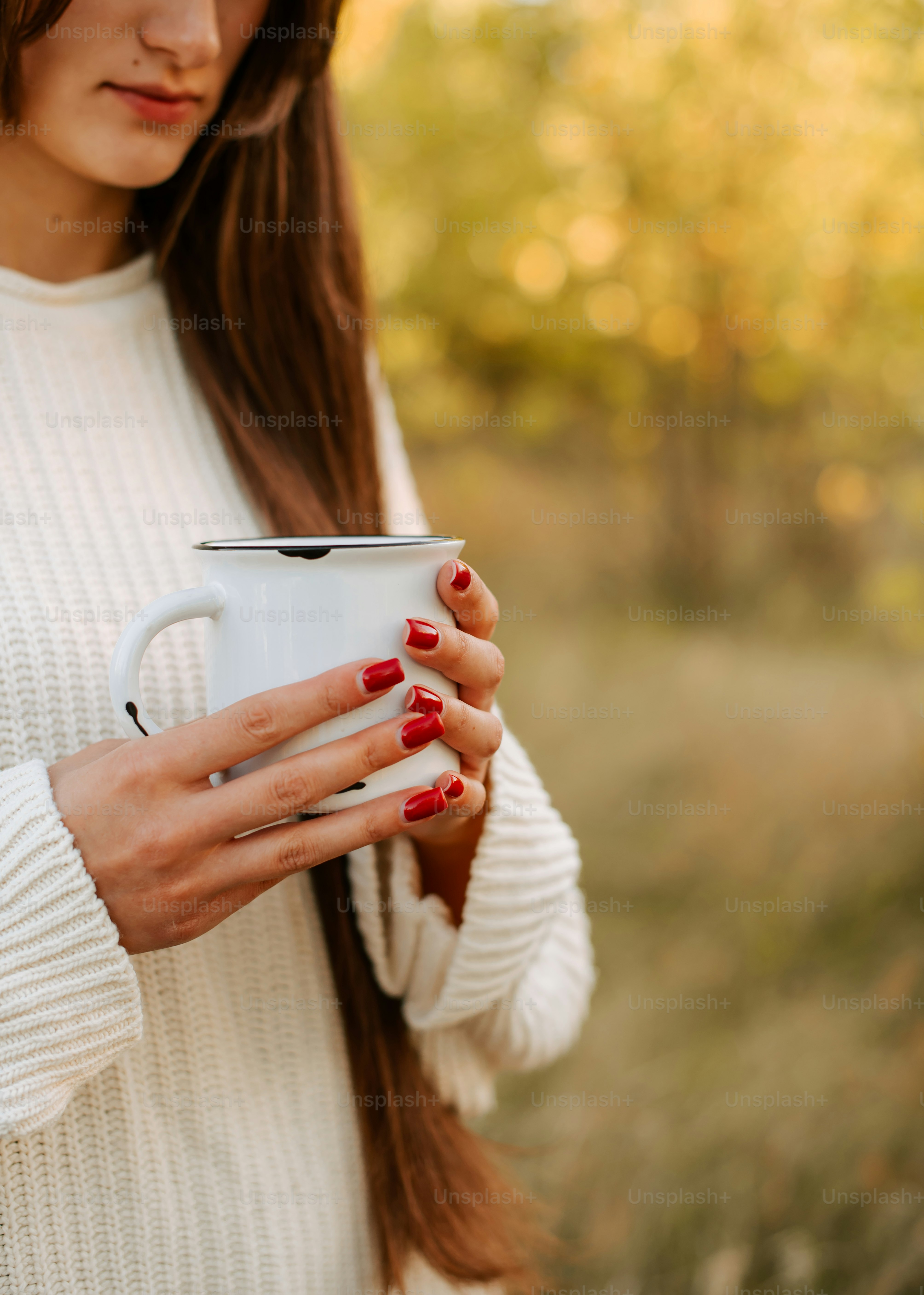 a woman holding a coffee mug in her hands