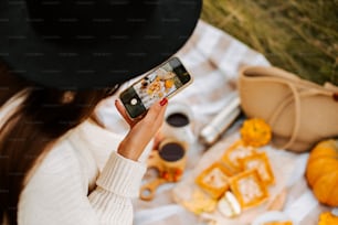 a woman taking a picture of food on her phone