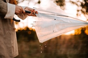 a person holding a white umbrella in their hand