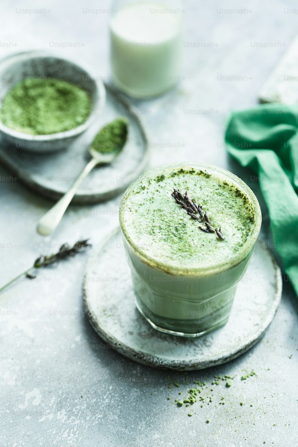 a cup of green tea on a plate