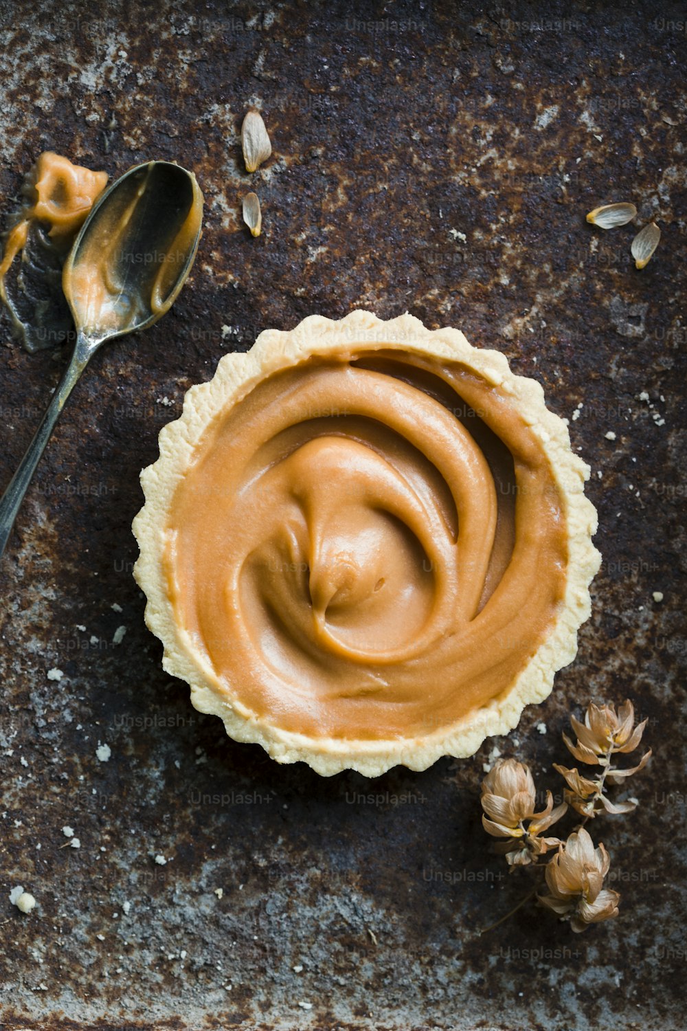 a pie crust with peanut butter and a spoon