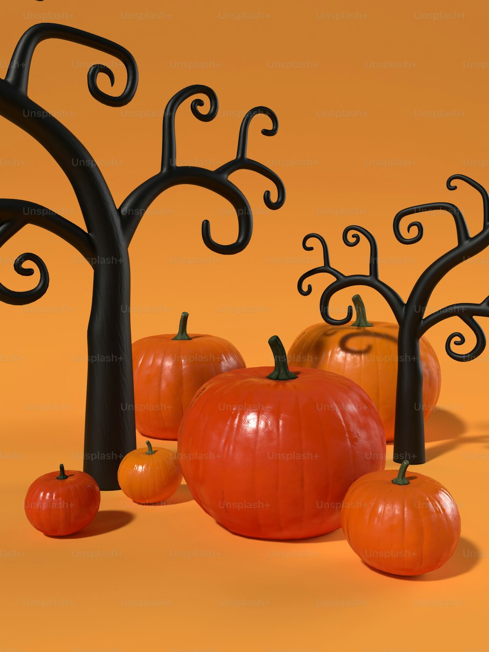 a group of pumpkins sitting next to a tree