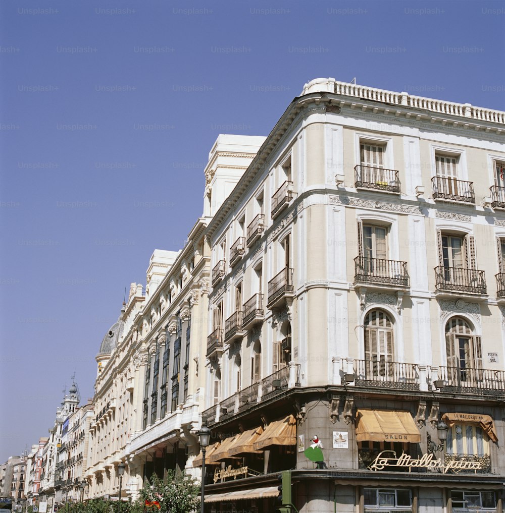 a large white building with balconies on the top of it