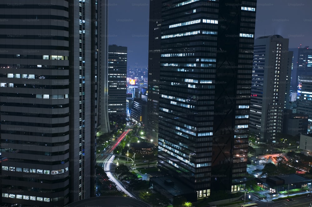 a view of a city at night from the top of a skyscraper