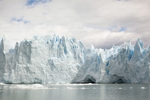 a large iceberg towering over a body of water