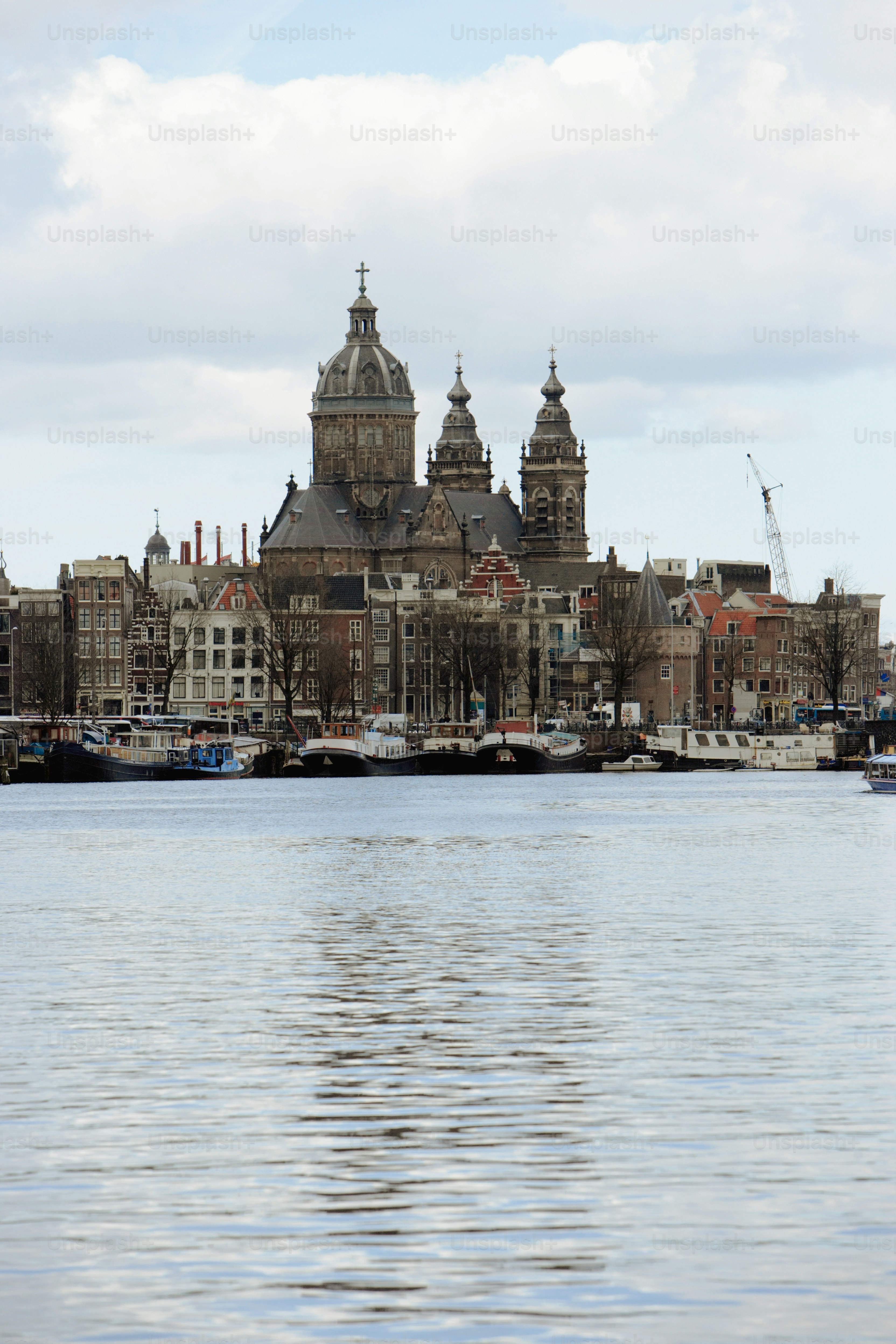 a body of water with boats in front of a large building