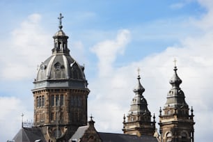 a large building with three towers and a cross on top